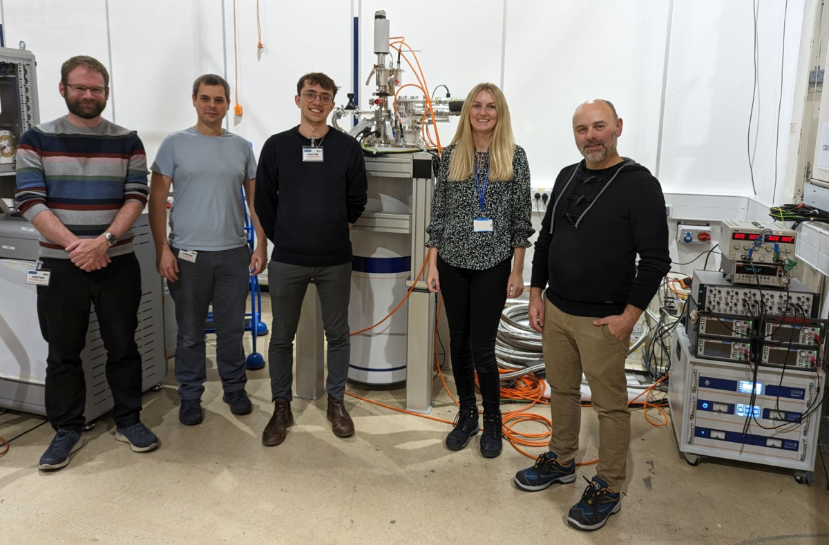 The Lancaster University team in the Apps Lab (from left to right Dr. Michael Thompson, Prof. Jonathan Prance, and George Ridgard) with Abi Graham and Ben Yager from Oxford Instruments NanoScience. 